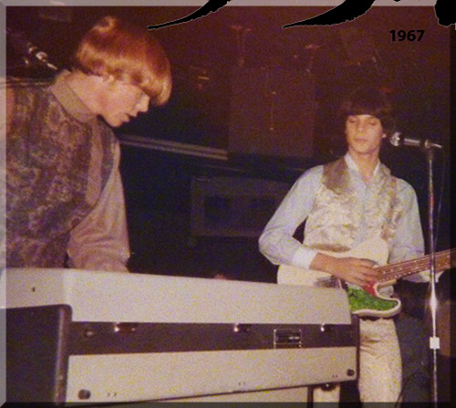 A nineteen sixty-seven vintage photo of Jerry Michelsen as a sixteen year old on stage, standing, playing an electric organ. Also pictured is the lead guitar player, Arthur Frick.
