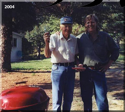 Photo of Jerry Michelsen in two thousand and four with his dad. They're standing next to a barbeque on the family farm in Minnesota.