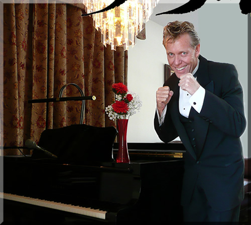 Photo of Jerry Michelsen in a boxing pose, in a tuxedo, next to a black grand piano, with a red flower in a vase.