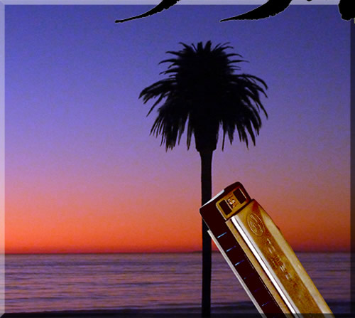 Surreal photo of a gigantic harmonica leaning against the iconic palm tree at Moonlight Beach in Encinitas, looking into a beautiful orange sunset