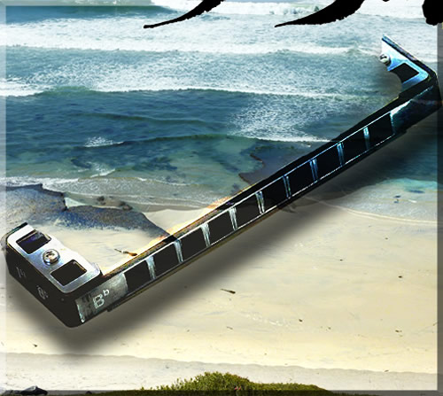 Surreal photo collage of a huge harmonica on Swamis Beach in Encinitas, California. The harmonica seems as large as a beached whale.